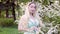 Young woman in flowering trees.