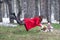 Young woman flying in the forest with a kettle.