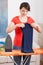 Young woman folding clothes