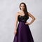 Young woman in formal dress with black sequin top and purple sa