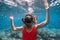 Young woman with freediving mask underwater in blue ocean