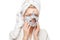 Young woman with fresh healthy skin and hairs aplying alginate mask and smiling. Cosmetology, beauty and spa. White