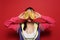 Young woman with fresh kiwano on red background. Exotic fruit