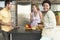 Young Woman With Friends At Kitchen Counter