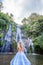 Young woman in front of Banyumala twin waterfalls