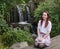 Young woman in front of a waterfall III