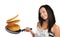 Young woman with a frying pan and pancakes