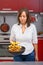 Young woman frying potatoes