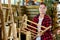 Young woman gardener is attentively examining a bamboo ladder