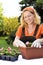 Young woman gardening - planting flowers