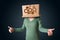 Young woman gesturing with a cardboard box on his head with spur