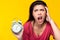 Young woman get insomnia She can not sleep until morning Girl holding alarm clock with messy hair Asian lady get unhappy and