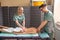 Young woman getting four hands back massage in beauty spa for body wellness.