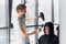 Young woman getting her hair dressed in hair salon by a handsome hairdresser hairstylist