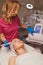 Young woman getting microcurrents skin cleansing and face treatment at beauty salon