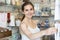 Young Woman In Gift Shop Choosing Greetings Card