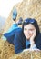 Young woman or girl on a bale of hay. a photo. portrait