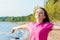 Young woman, girl on the beach enjoys and breathes clean air