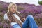 Young Woman Girl in Field of Purple Heather Flowers