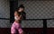 Young woman or girl mixed martial arts boxer fighter training in the octagon cage. Female bare knuckle boxing workout for new comp