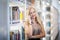 Young woman or girl standing in bookstore or library and look on book