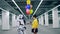 Young woman gives many colorful balloons to her friend cyborg.