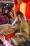 Young woman giving away rice at Guru Nanak Gurpurab celebration, New Delhi, India