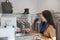 Young woman giving credit card to cashier