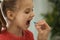 Young woman giving pill to her daughter, closeup