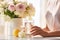 Young woman with glass of water and flowers on table, concept of well-being, health-conscious, closeup photo in pastel tones.