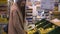 Young woman with glasses and a coat in the supermarket chooses apples.