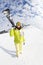Young woman going mountain ski on winter resort