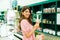 Young woman going shopping and buying beauty products in the store