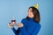 Young woman in golf on a blue background celebrates a birthday