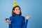 Young woman in golf on a blue background celebrates a birthday