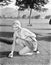 Young woman on a golf course placing a golf ball