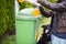 Young woman grabbing a plastic bag in a park to tidy up after her dog later