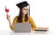 Young woman with a graduation hat and diploma sitting with a laptop and books