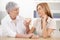 Young woman and grandmother chatting at home