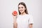 Young woman with grapefruit cut in half, healthy life concept . photo of attractive girl holding a cut piece of pomelo in her hand