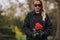 Young woman at graveyard with fresh roses