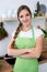 Young woman in green apron is going for cooking in a kitchen