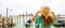 Young woman with green dress holding her hat when looking to Venice Lagoon. Panoramic banner view of traveler girl in