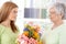 Young woman greeting mother at mother\'s day