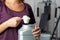 Young Woman In Gym Taking Nutritional Supplement