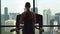 Young woman in a gym on top of a skyscraper training on a running track with a view on a whole city