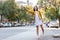 Young woman hailing a taxi ride. Beautiful charming woman hailing a taxi cab in the street. Businesswoman trying to hail a cab in