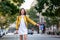 Young woman hailing a taxi ride. Beautiful charming woman hailing a taxi cab in the street. Businesswoman trying to hail a cab in