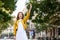 Young woman hailing a taxi ride. Beautiful charming woman hailing a taxi cab in the street. Businesswoman trying to hail a cab in