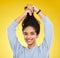 Young woman, haircare and playful, smile in portrait and hair in air with gen z and fashion on yellow studio background